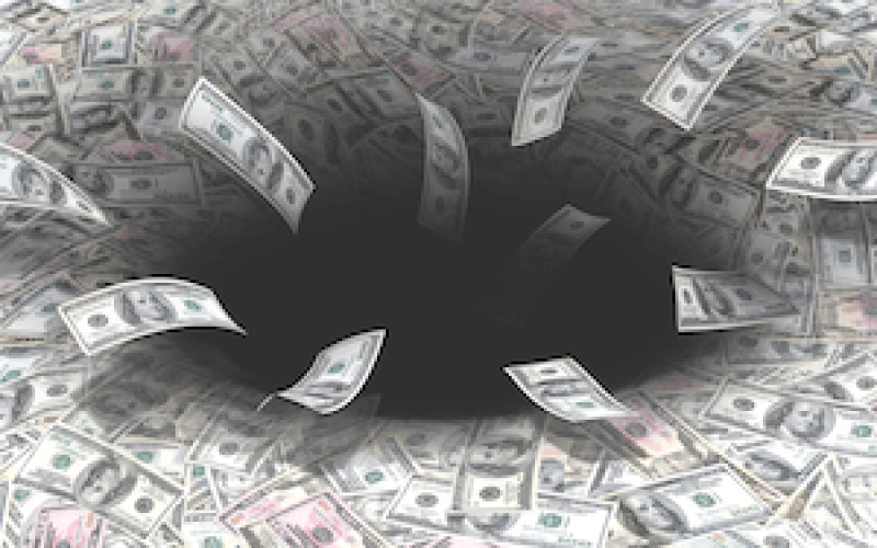 Church or Charity Losing income. Picture of dollars falling into a black hole.